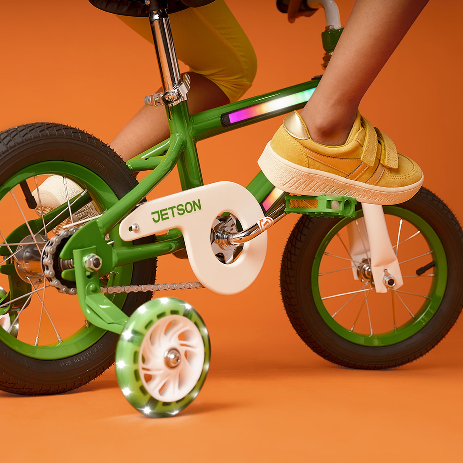 close up of a kid's foot on pedal and light up training wheels
