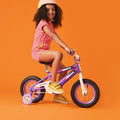 young kid riding purple light up bike
