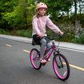 young girl riding metallic pink light rider 20 bike