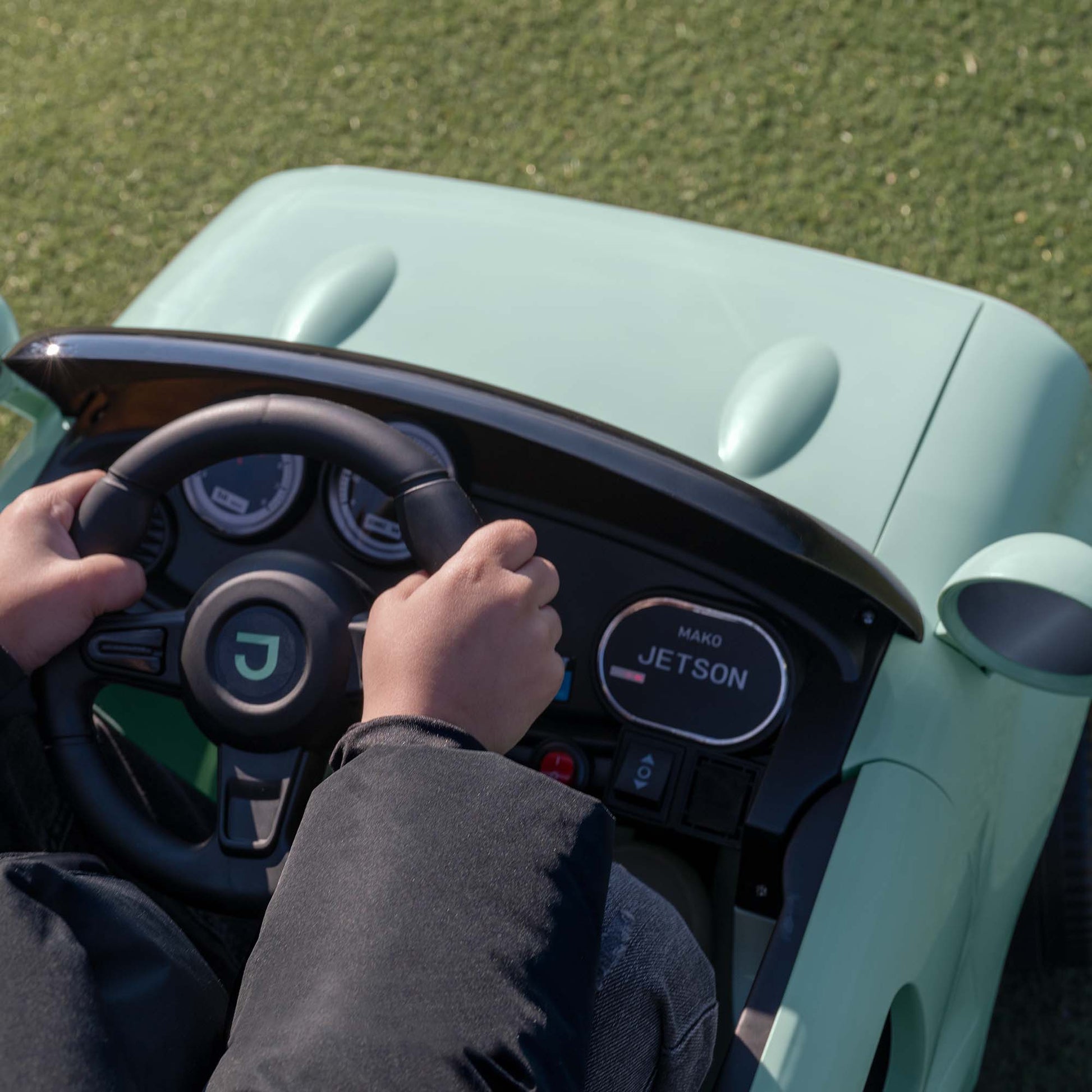 close up of a kid's hands on the steering wheel