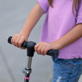 close up of a kid's hands on the handlebar