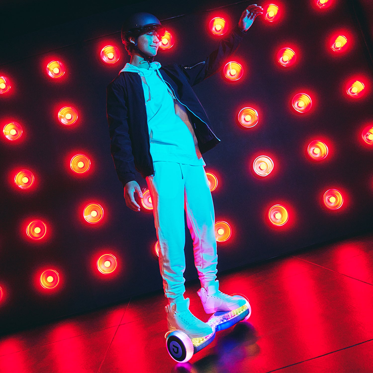 guy in a helmet riding the lit up pixel hoverboard