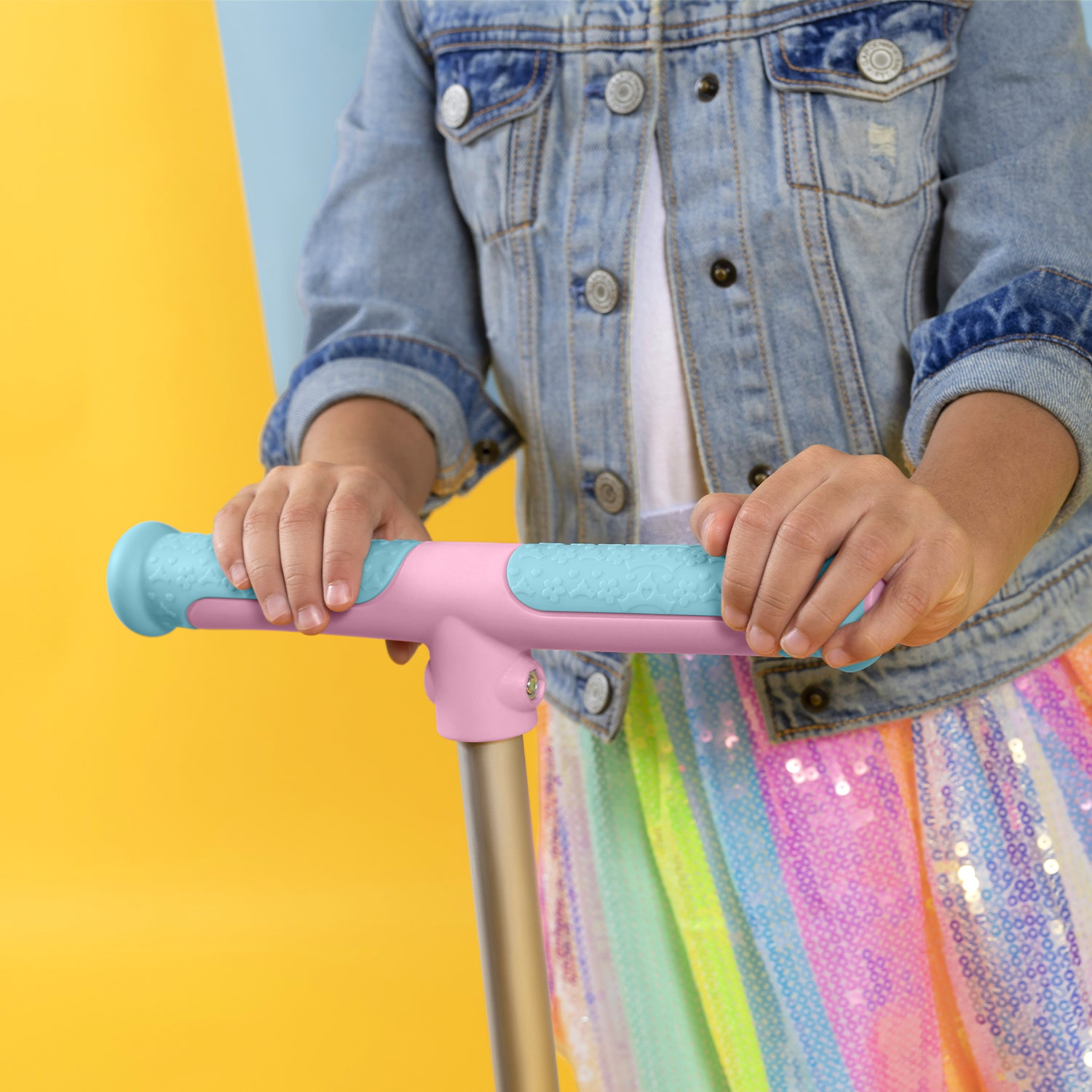 close up of girl's hands on the handlebar on the  customizable disney princess kick scooter