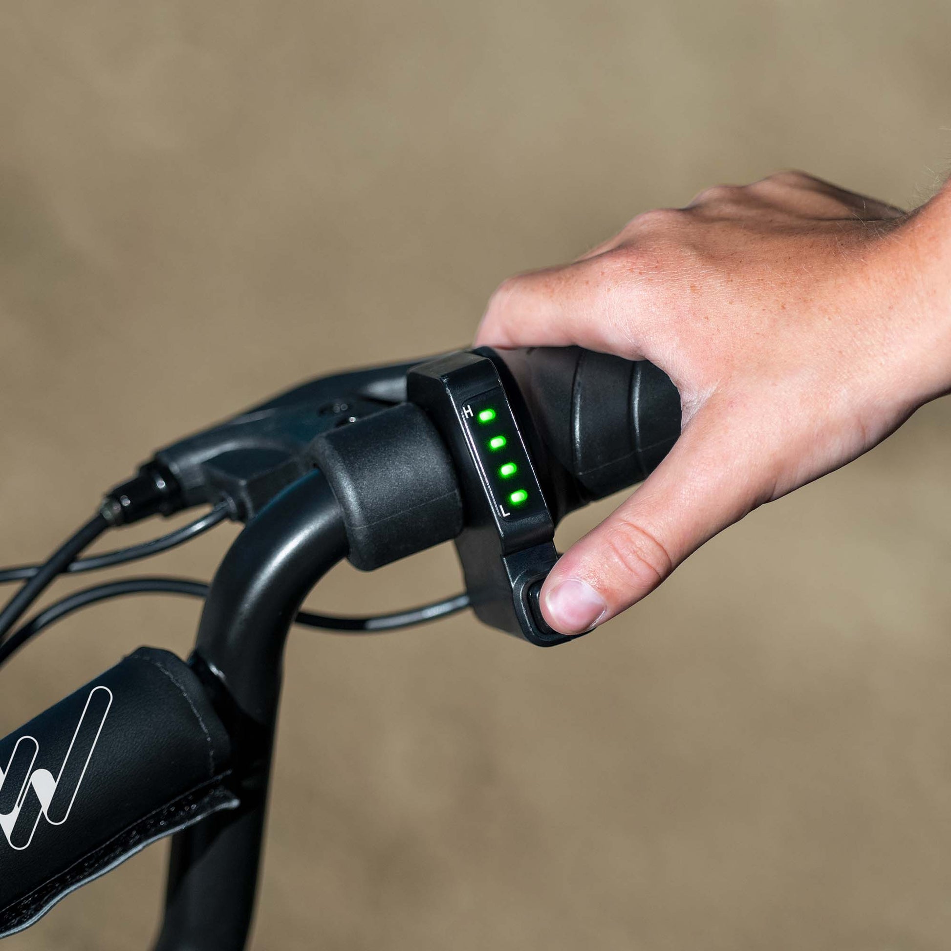 close up of battery indicator light with thumb on power button