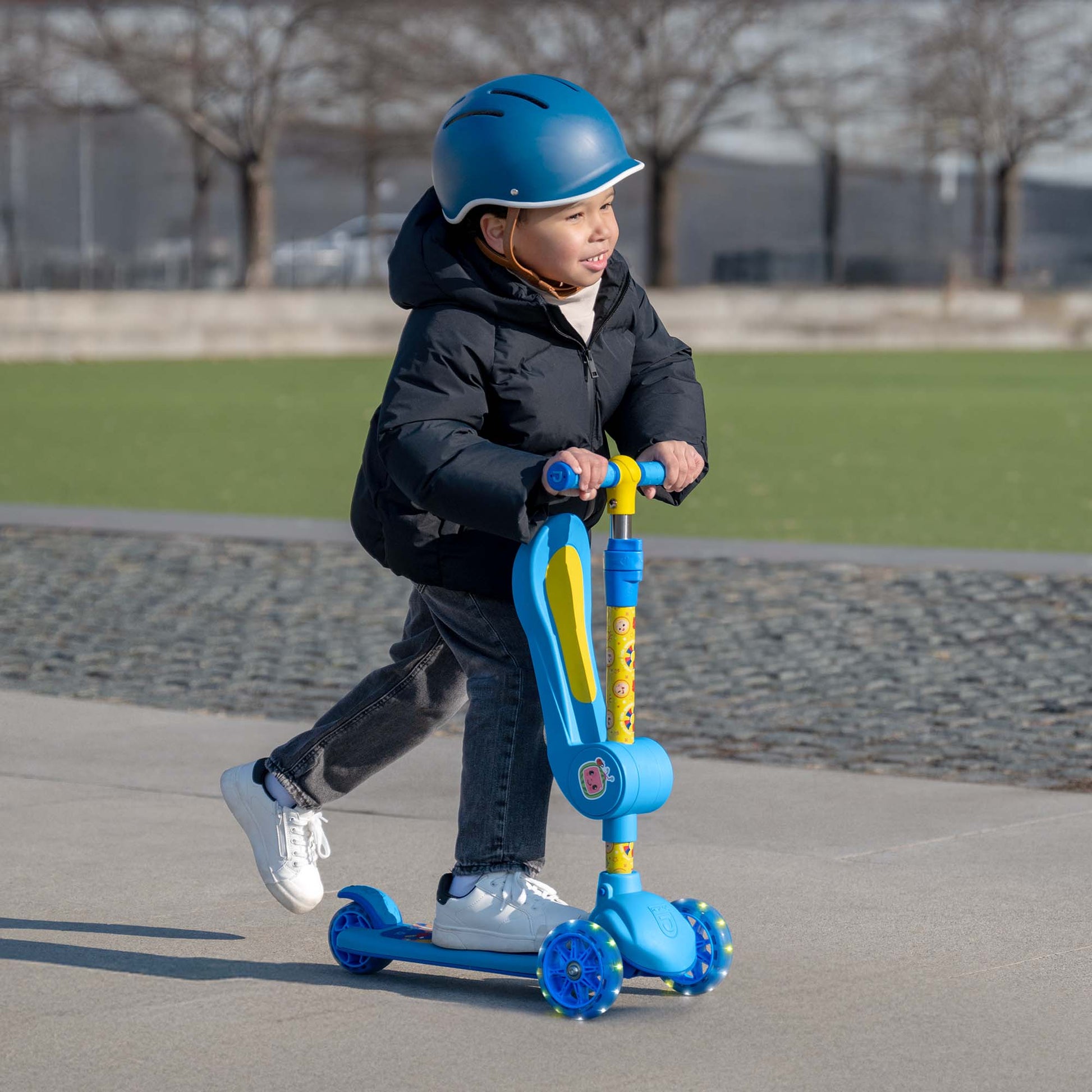 little kid riding cocomelon kick scooter