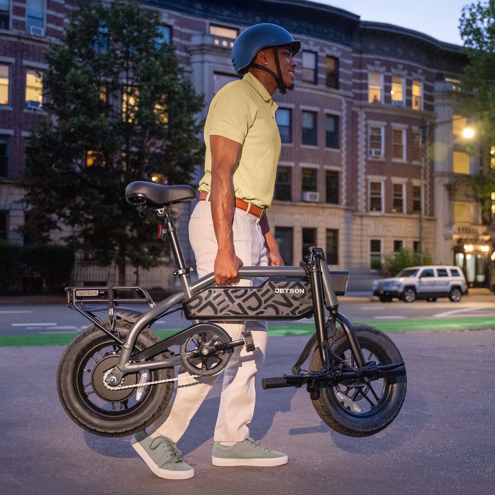person carrying folded shadow e-bike