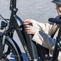 person removing battery in venture e-bike
