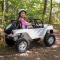 young girl driving vega ride-on with a spare tire attached to the back