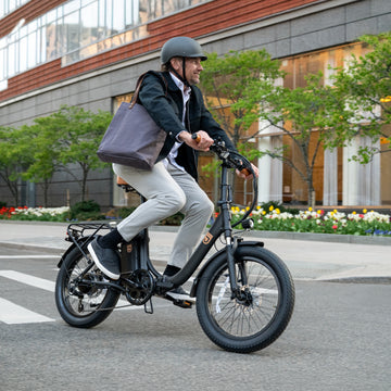 man riding Venture electric bike down the street