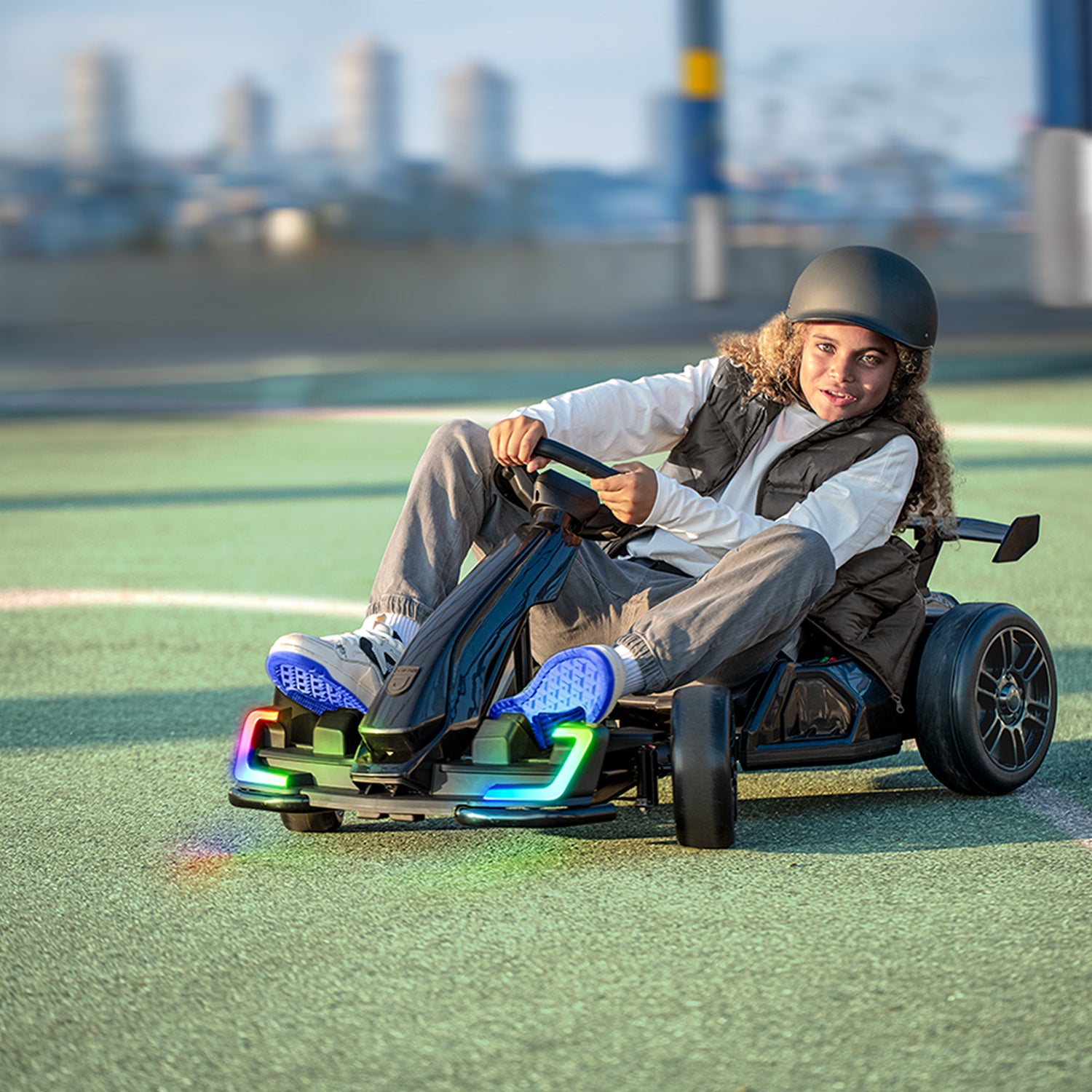 kid turning steering wheel on volt x electric go kart