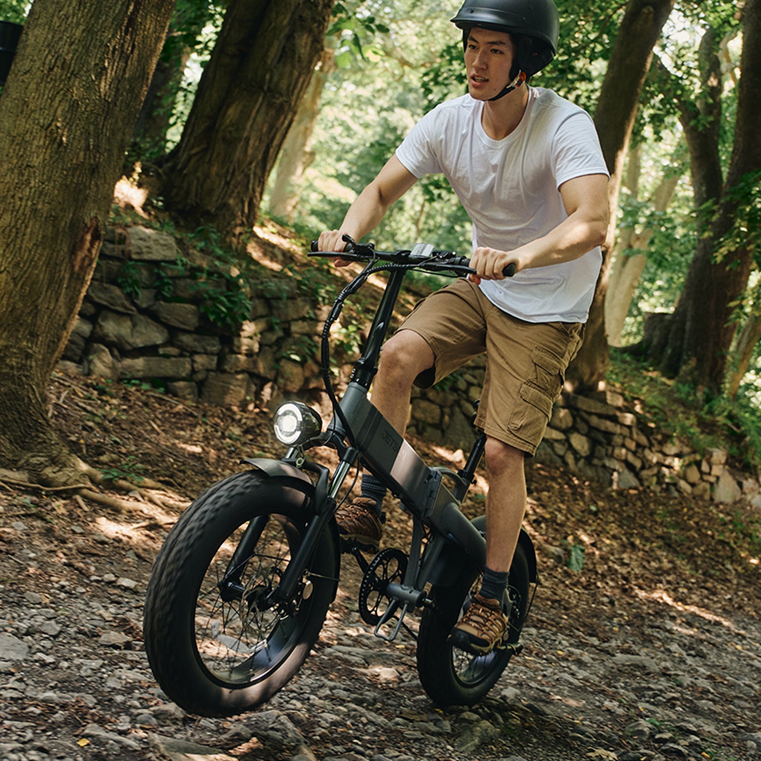 person riding warren electric bike through the woods