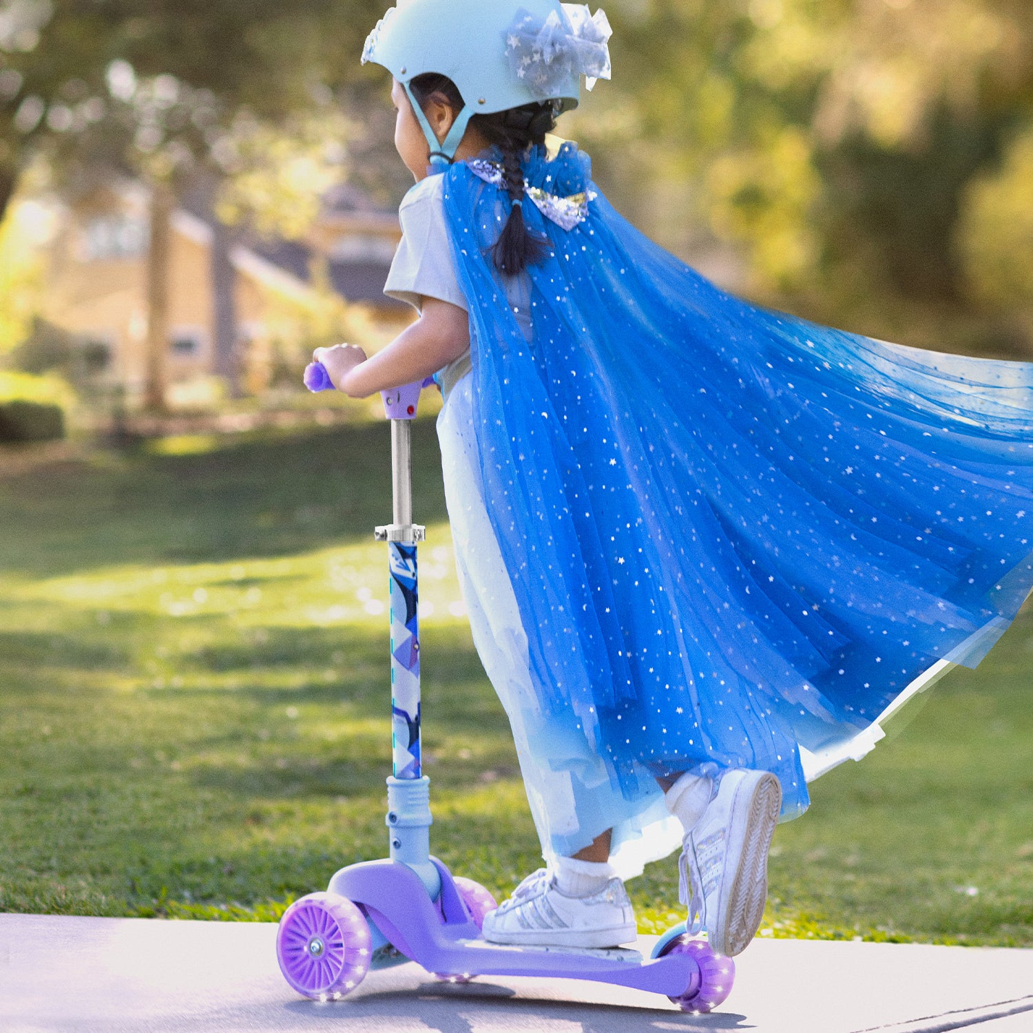 a girl riding her Frozen 3 wheel kick scooter 
