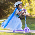 a girl riding through a park on her Frozen 3 wheel kick scooter 