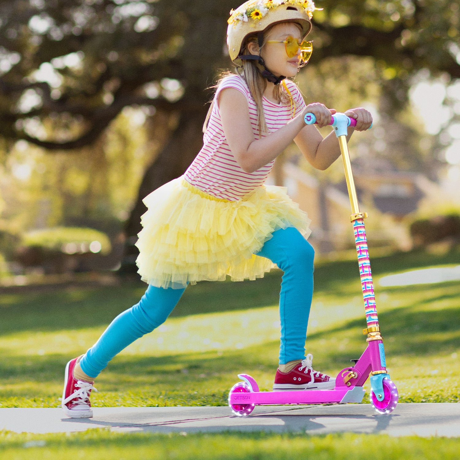 girl having fun pushing herself off to get momentum on her Disney kick scooter