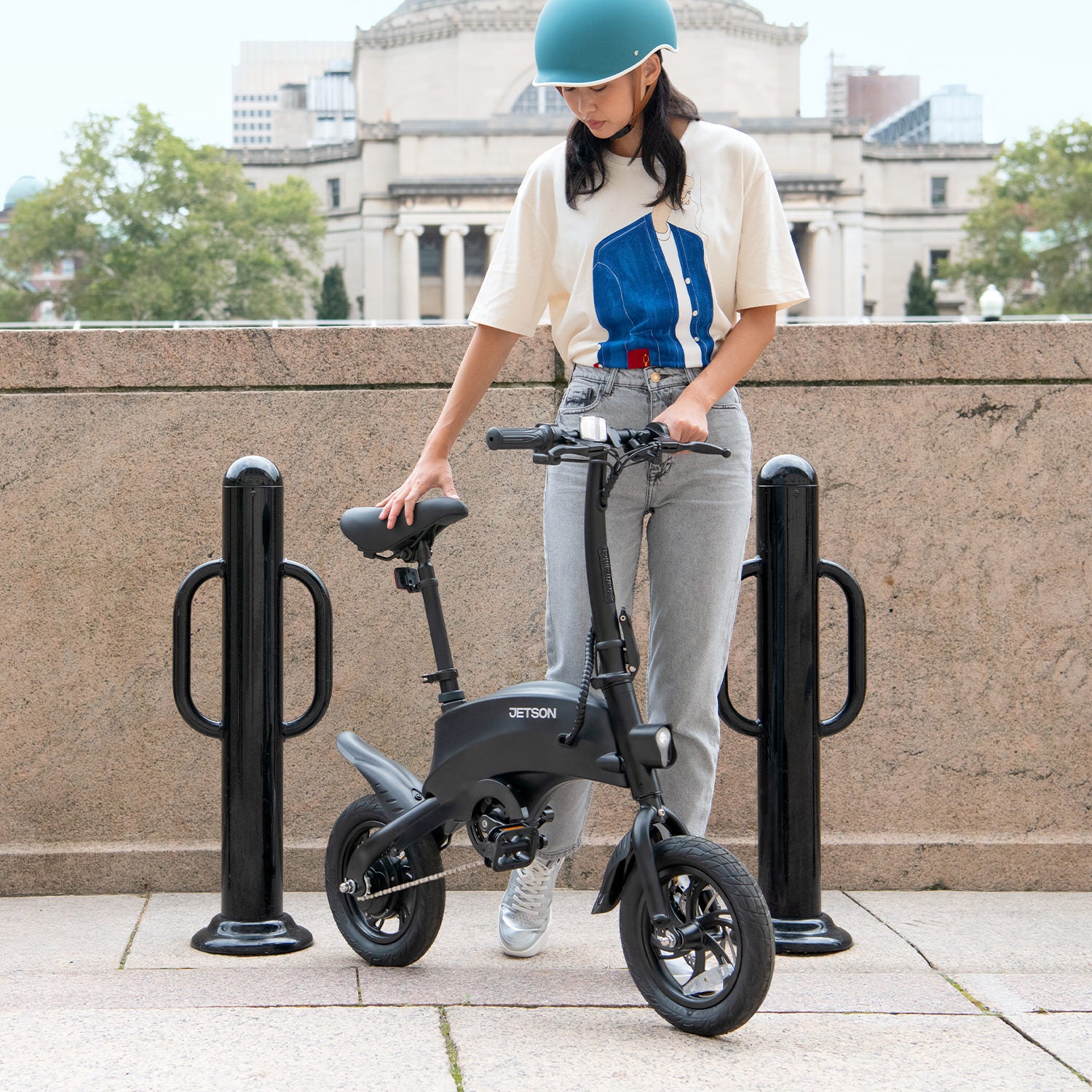 person standing next their Axle bike and looking down at it 