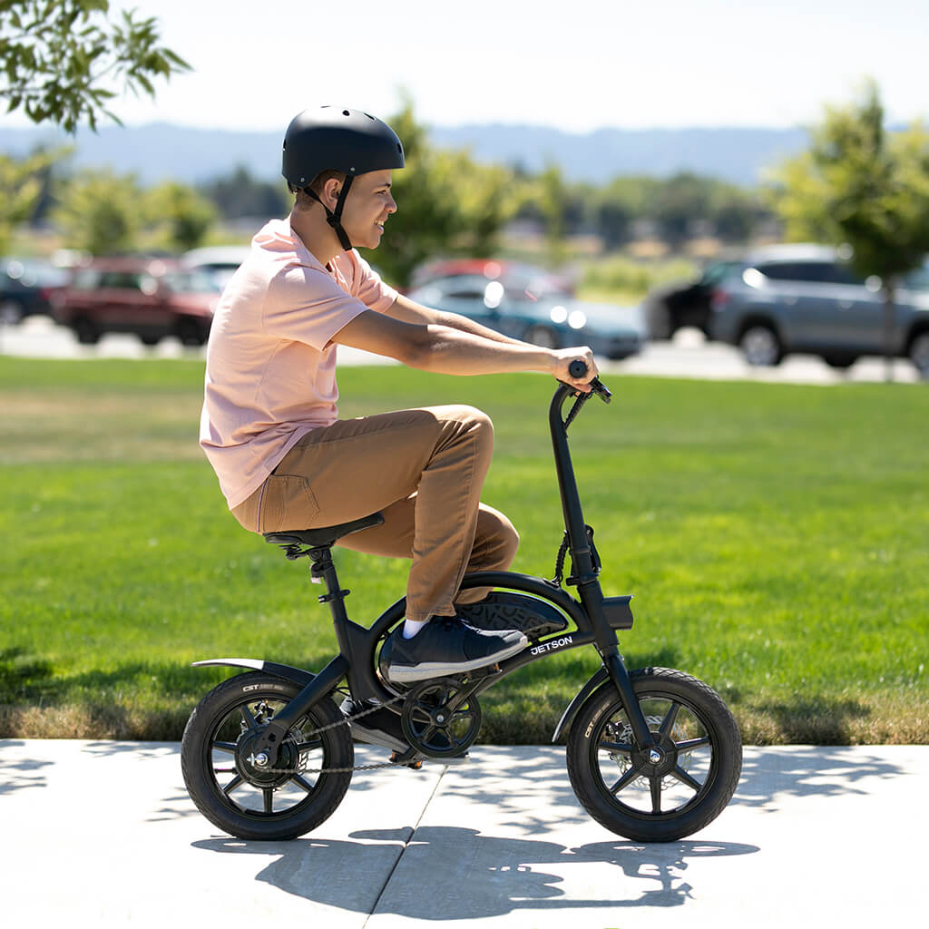 person riding bolt pro on sidewalk