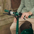 close up of Bolt Pro handlebar with person's left hand on the brake