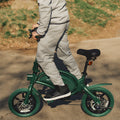 person standing on a green Bolt Pro bike