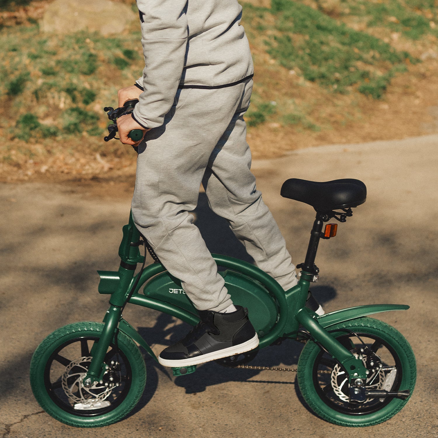 person standing on a green Bolt Pro bike