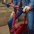 close up of person sitting on Bolt with left hand on brake lever