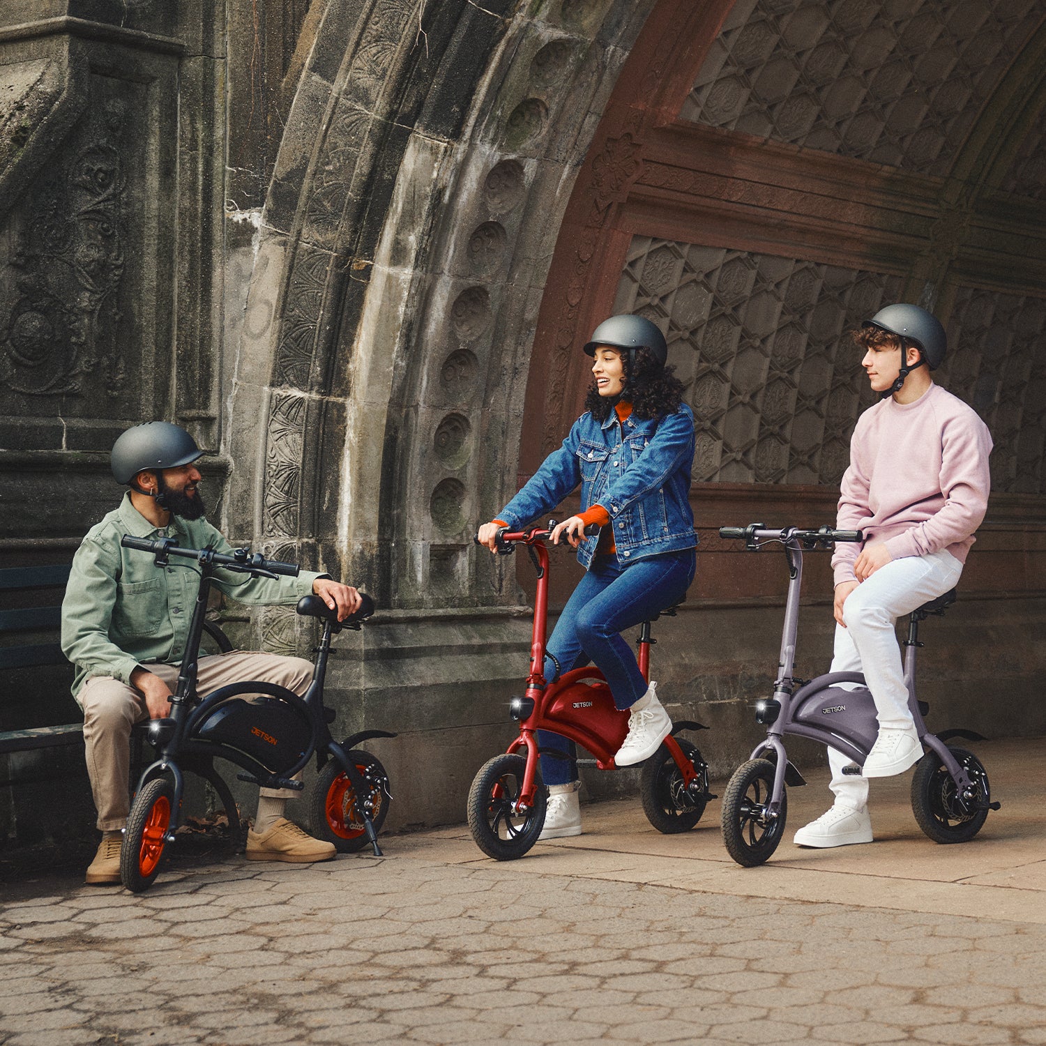 group of three people sitting with their Bolt bikes