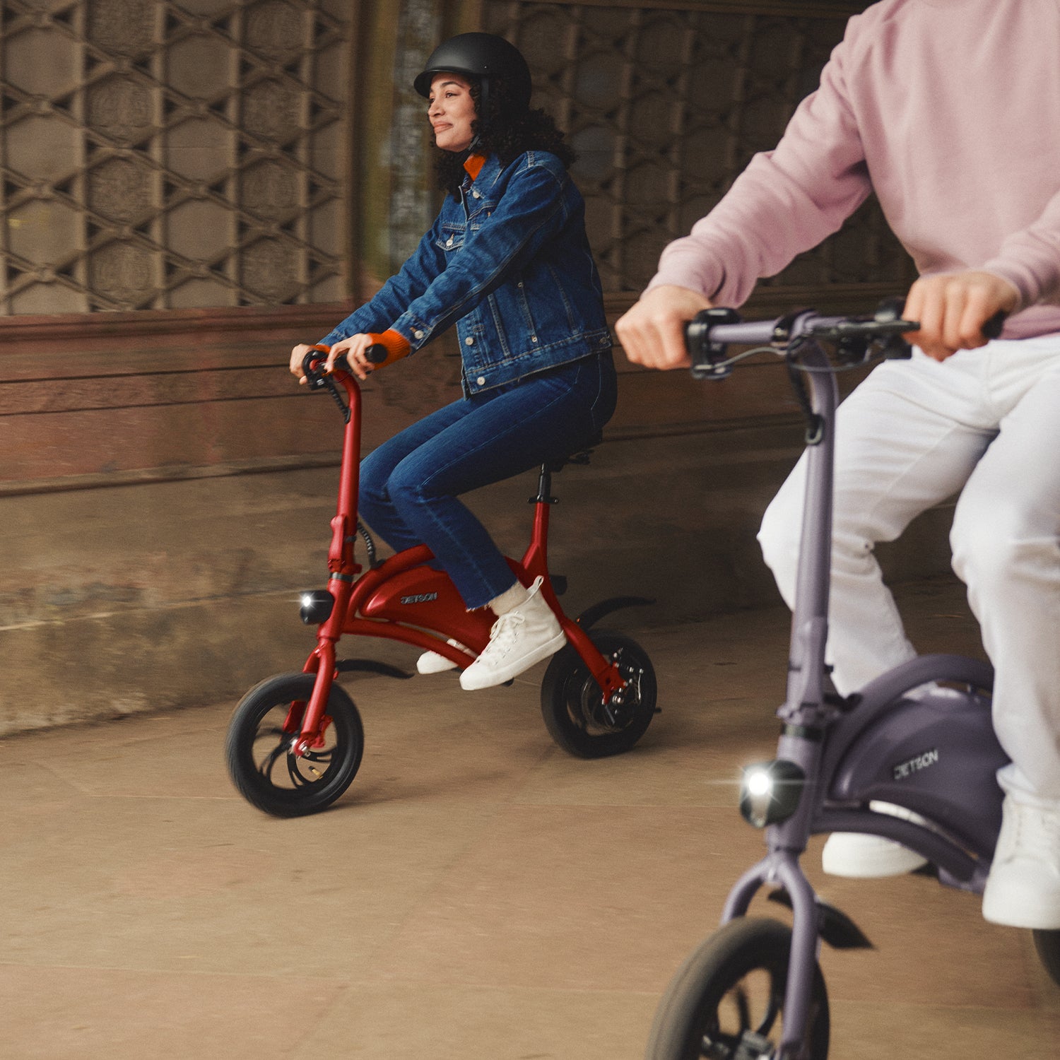 two people riding Bolt bikes through a tunnel