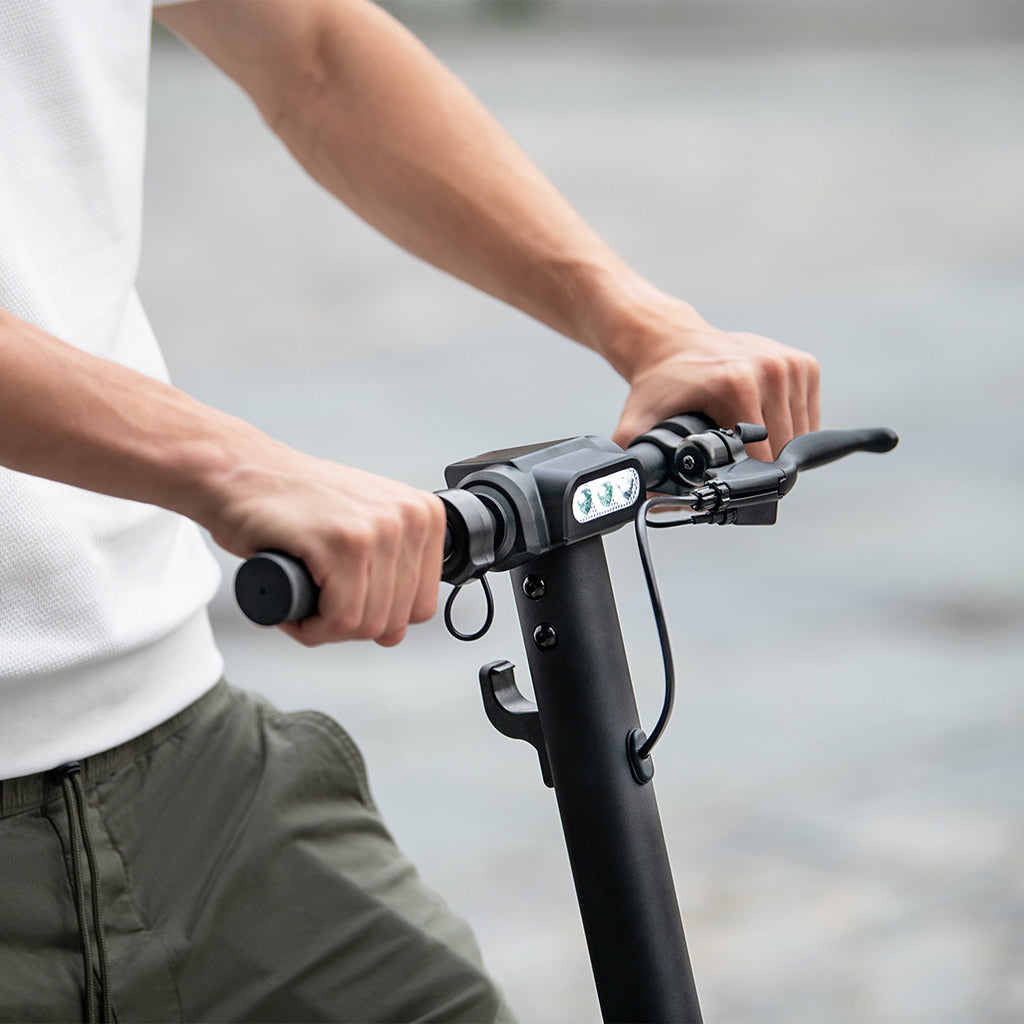 close up of person's hands on the handlebars 