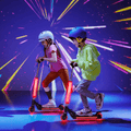 two kids riding their light up cosmo kick scooters