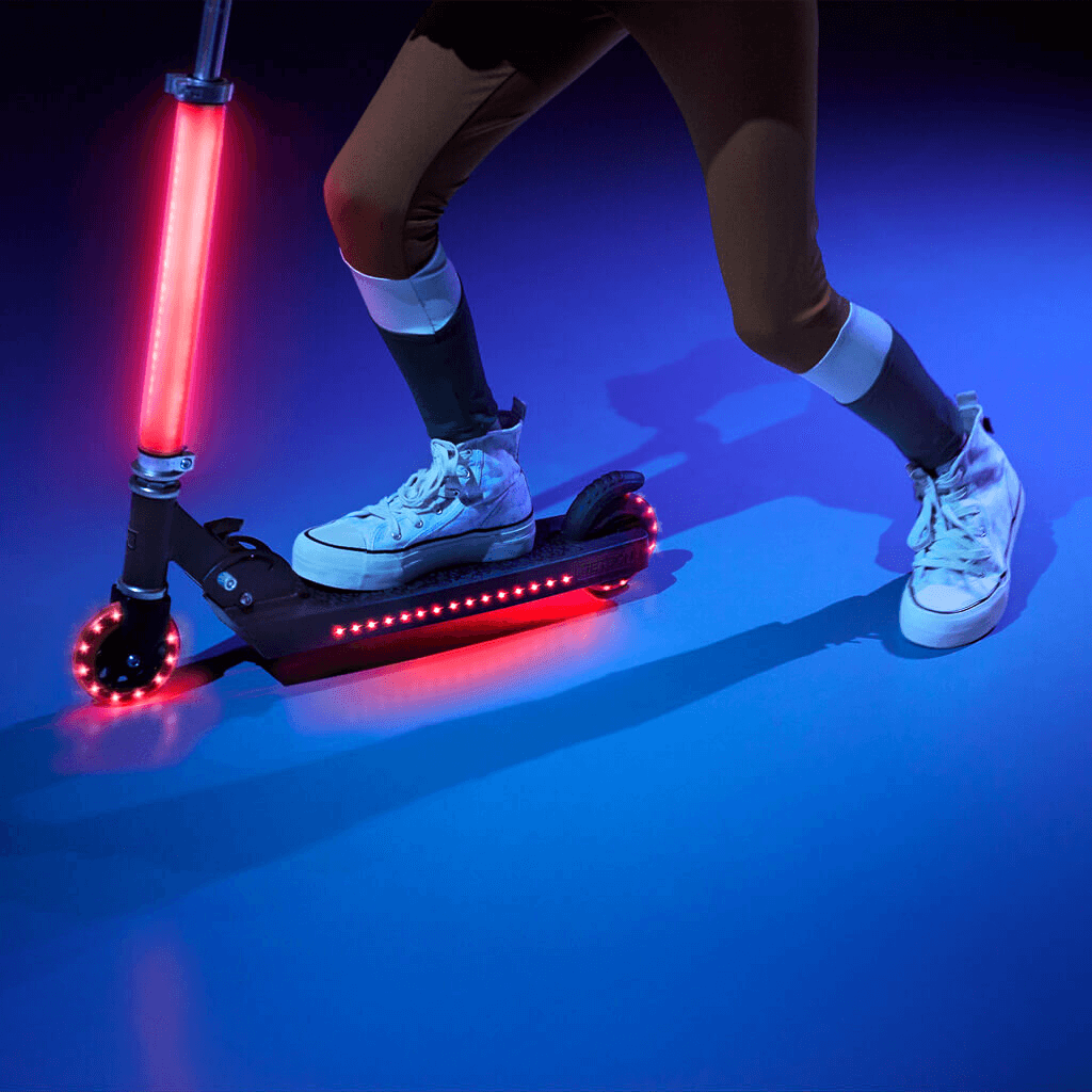 close up of a kid riding on the light up cosmo kick scooter