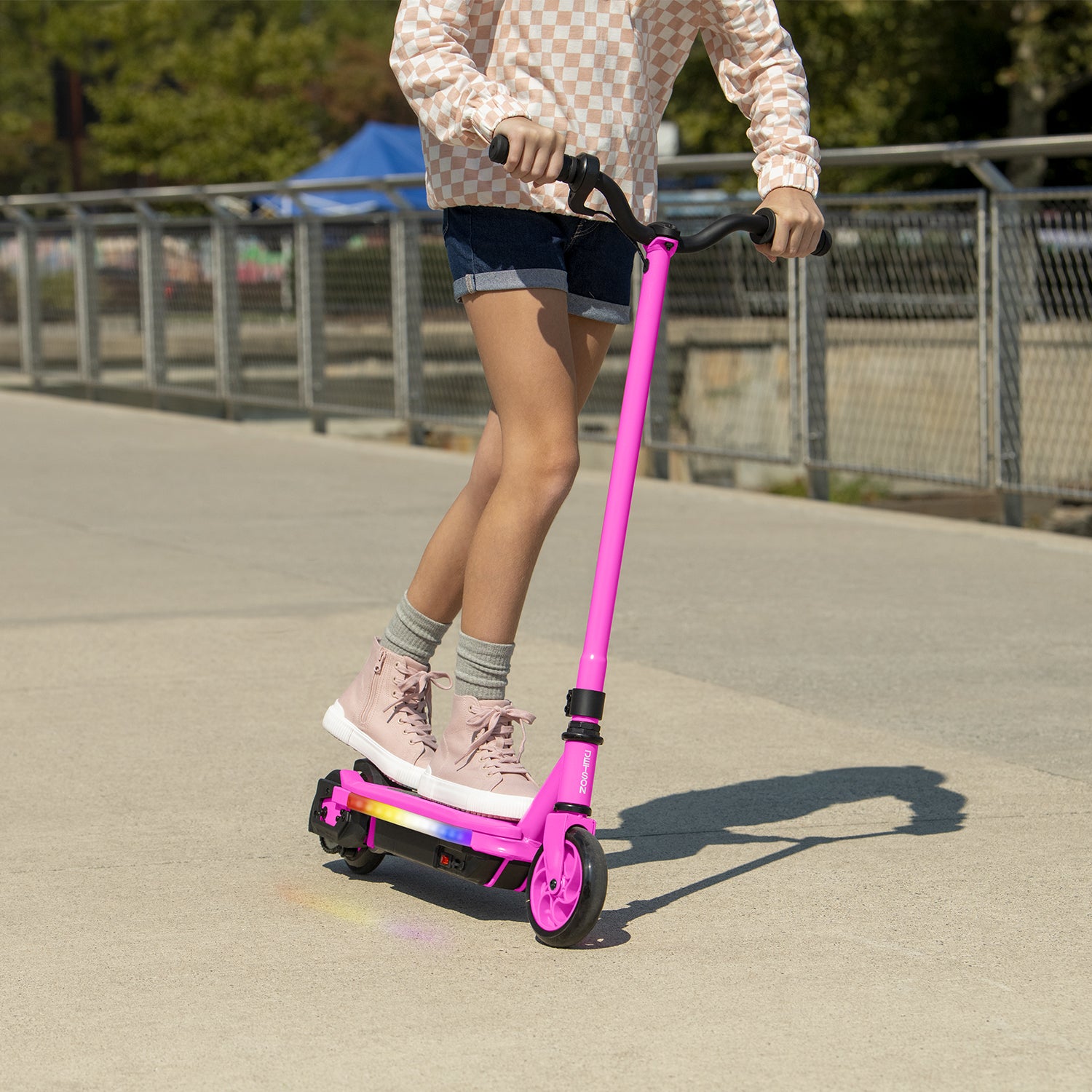 close up of kid riding pink echo x electric scooter