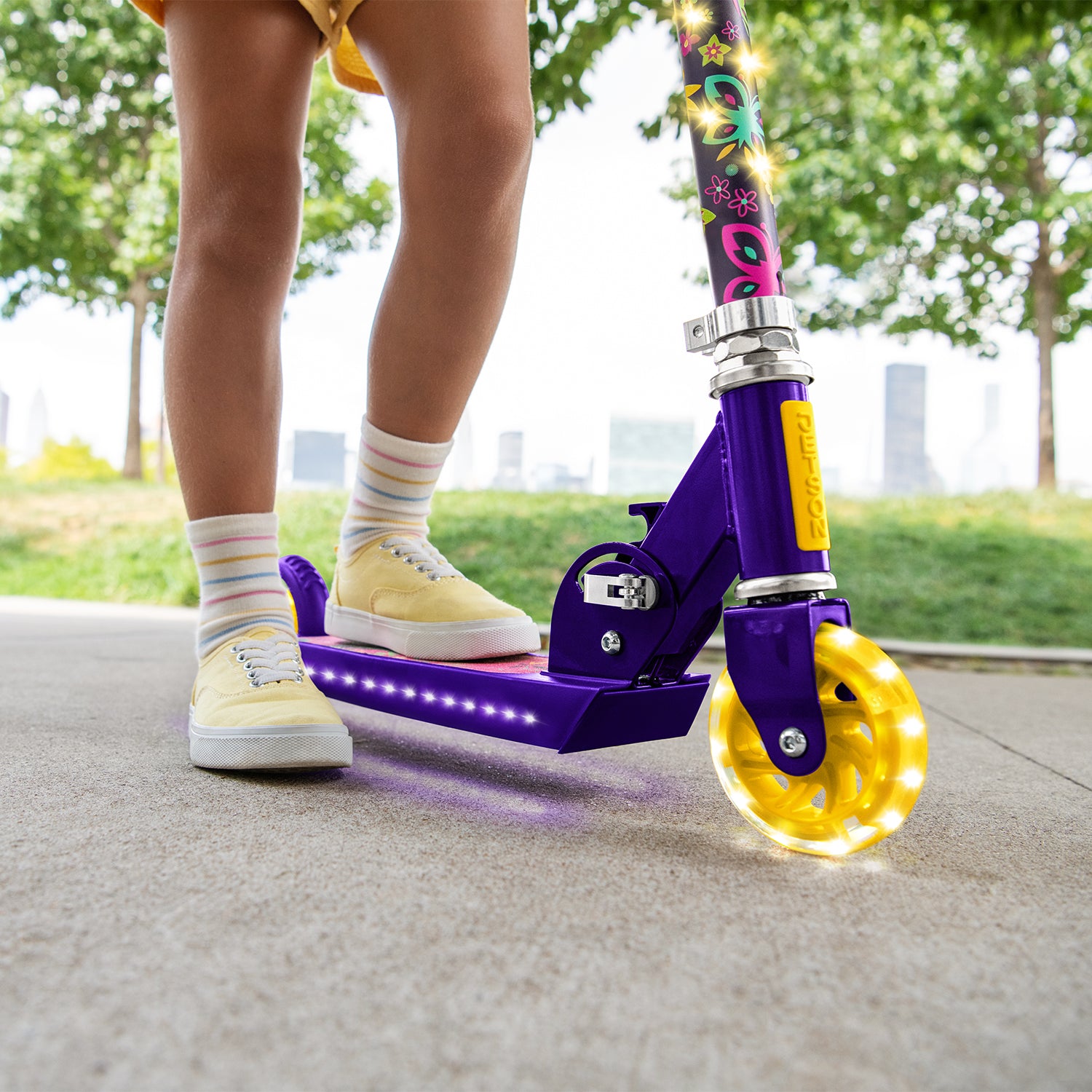 close up of the light up deck and wheels on the disney encanto kick scooter