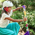 young girl adjusting the handlebar height on the disney encanto electric scooter