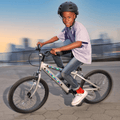 young kid riding chrome colored light up bike in a park