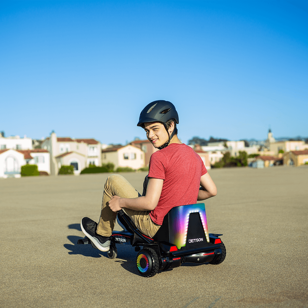 teenager sitting on force hoverboard combo and looking over his shoulder