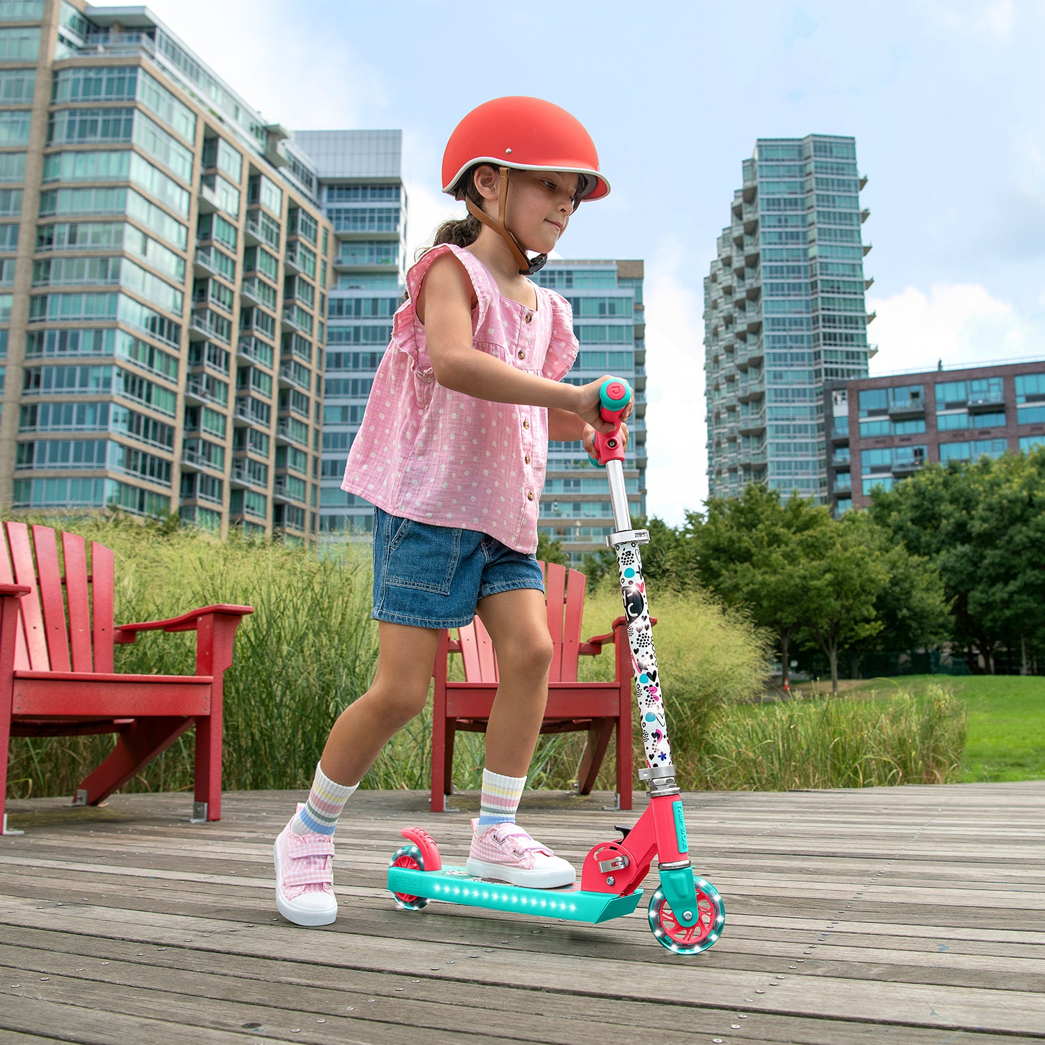 young girl riding the gabby's dollhouse kick scooter