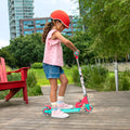 young girl holding the handlebar on the gabby's dollhouse kick scooter