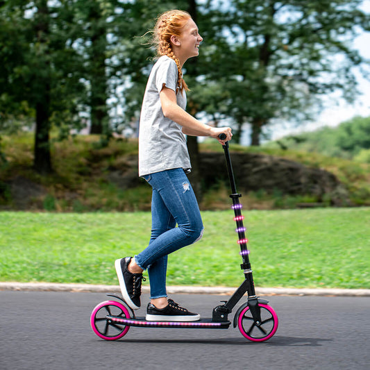 kid riding pink helix scooter