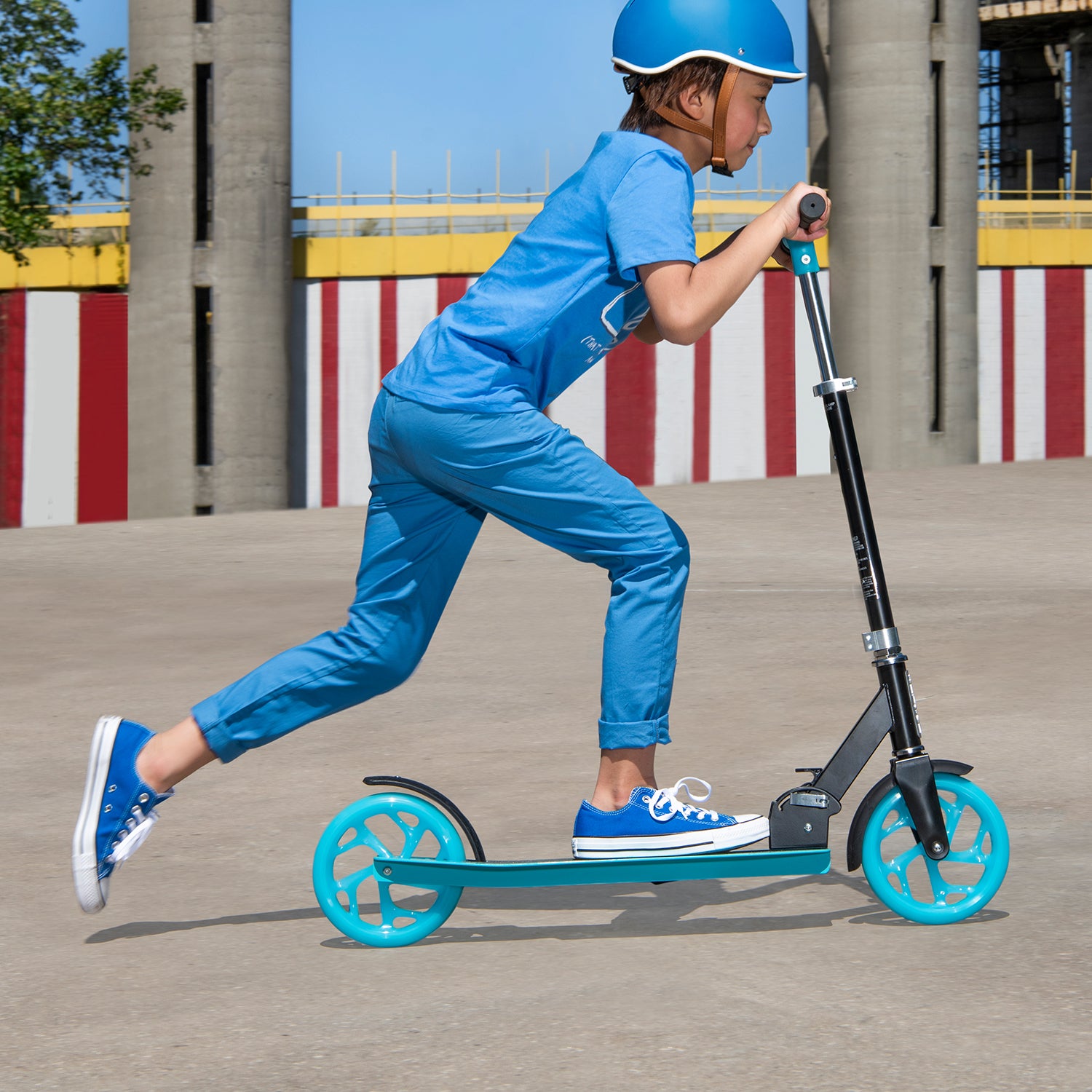 kid riding blue hex scooter