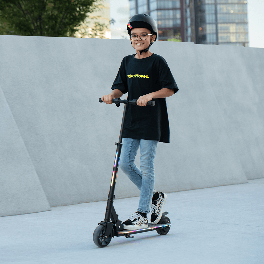 young person riding e- scooter while smiling 