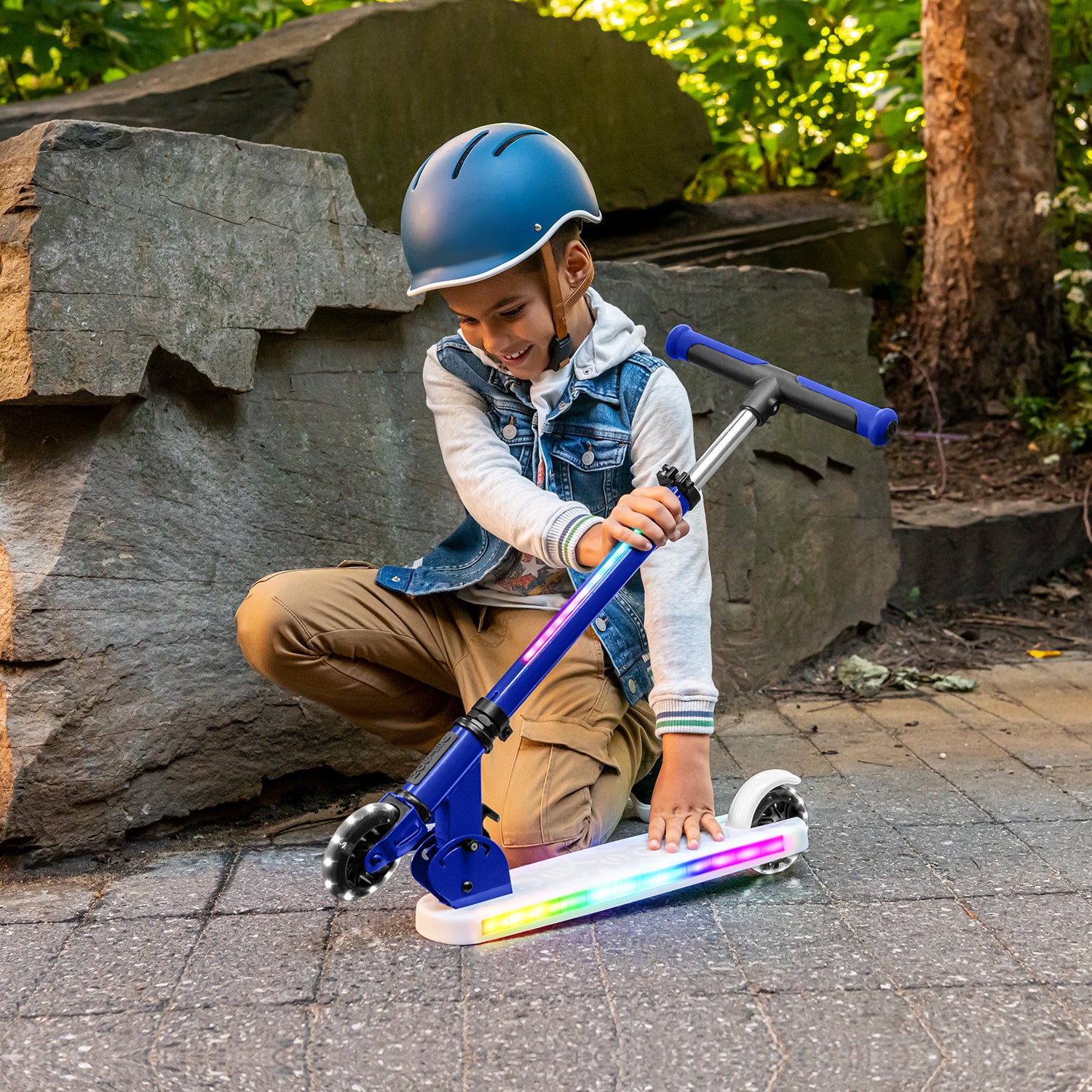kid folding the blue helio x kick scooter