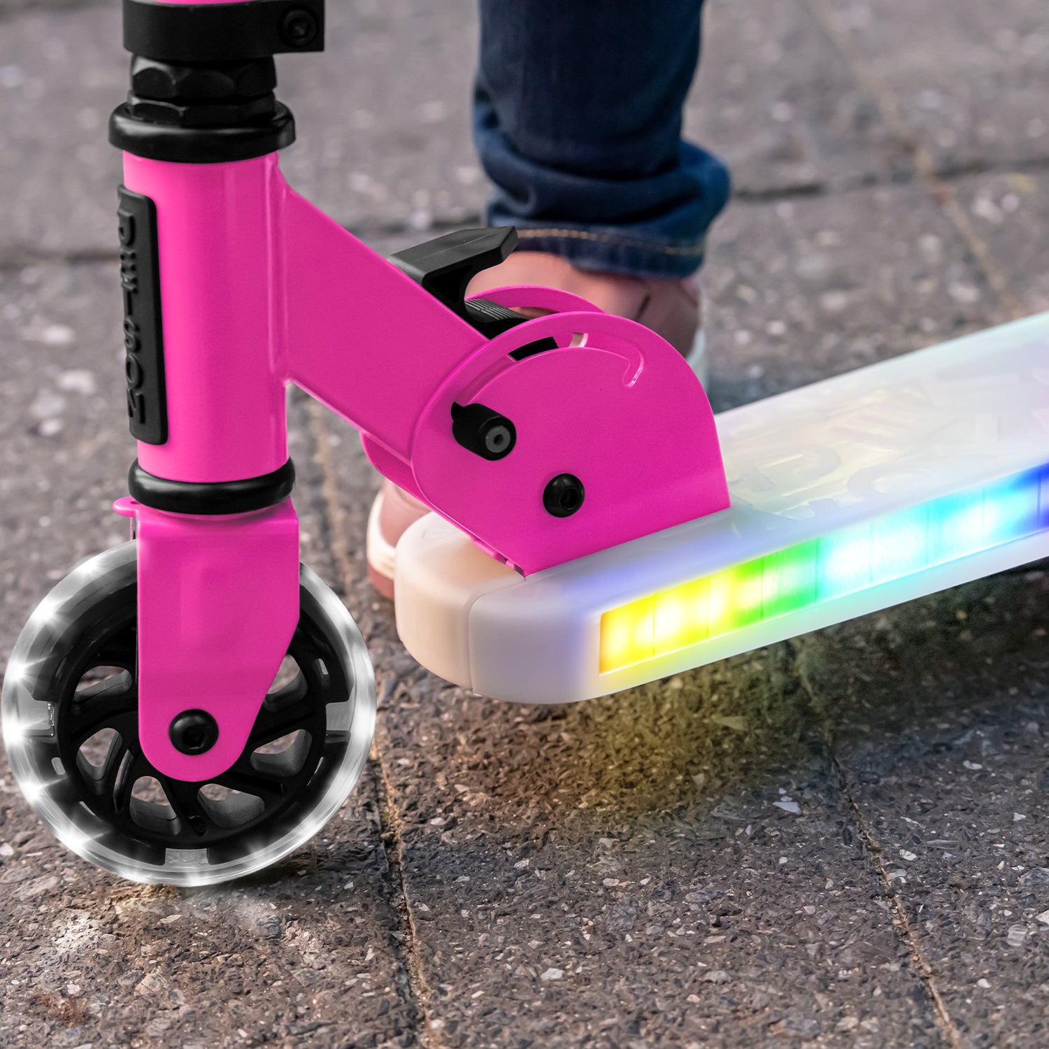 close up of light up wheel and deck on pink helio x kick scooter