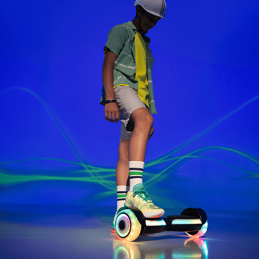 young person standing with one foot on the Input hoverboard