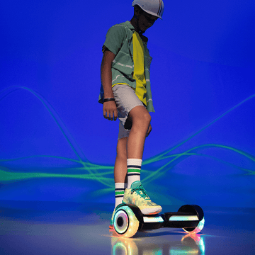 young person standing with one foot on the Input hoverboard