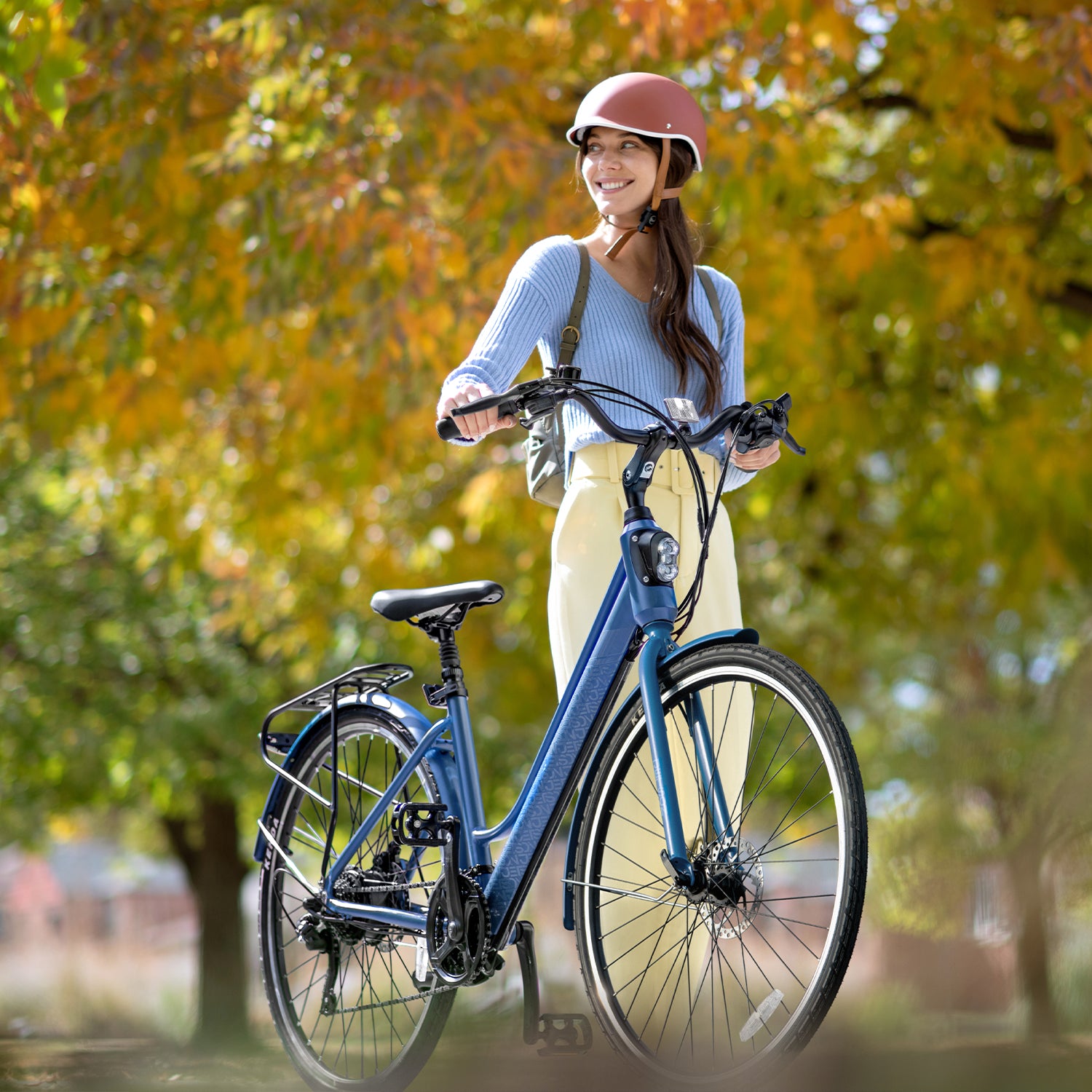 person standing and holding onto Journey electric bike in a park