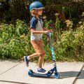 young kid riding the jurassic park kick scooter