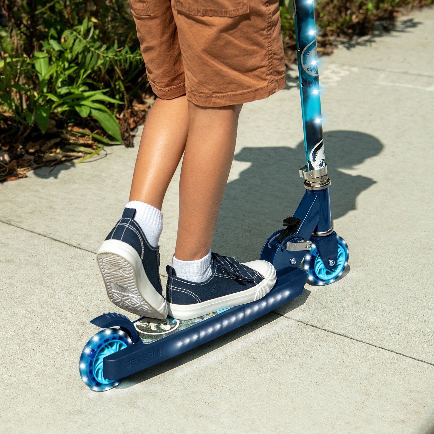 close up of a kid's feet on the jurassic park kick scooter