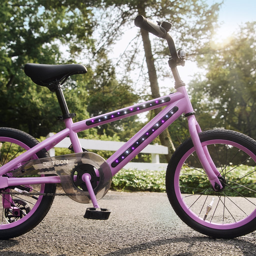 purple light up bike parked in a park