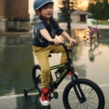 young kid riding black light up bike