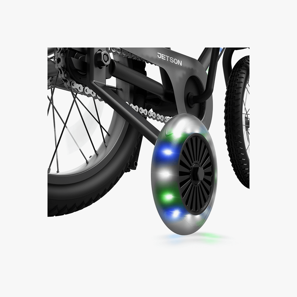 close up of light up training wheels on black light up bike
