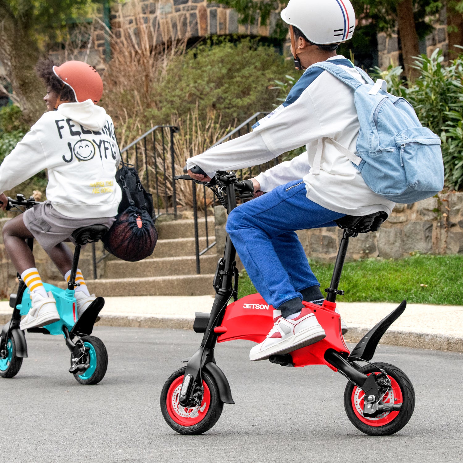 two people riding the blue and red LX10s out on the street